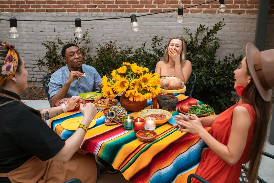 Friends laughing around a table